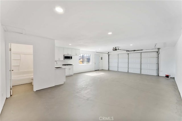 18346 Hackberry St, Hesperia, CA 92345 - garage featuring recessed lighting, a sink, and a garage door opener