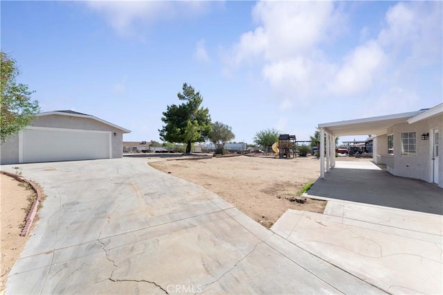 18346 Hackberry St, Hesperia, CA 92345 - view of yard with concrete driveway and a playground