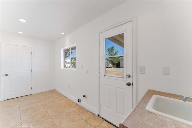 18346 Hackberry St, Hesperia, CA 92345 - entryway featuring a sink, light tile patterned floors, recessed lighting, and baseboards