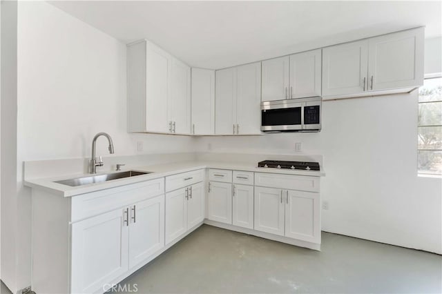 18346 Hackberry St, Hesperia, CA 92345 - kitchen with stainless steel microwave, a sink, finished concrete flooring, gas stovetop, and light countertops