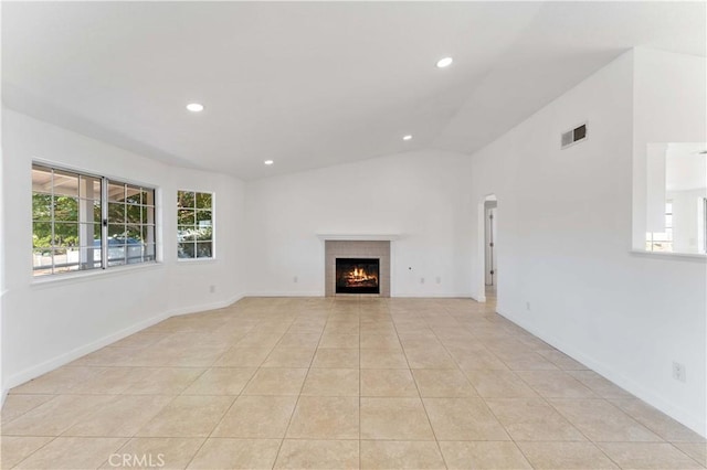18346 Hackberry St, Hesperia, CA 92345 - unfurnished living room with healthy amount of natural light, recessed lighting, a fireplace, light tile patterned flooring, and vaulted ceiling
