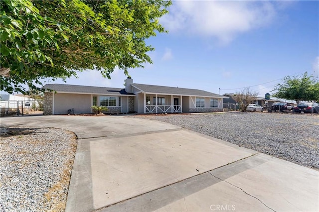 18346 Hackberry St, Hesperia, CA 92345 - ranch-style home with a porch, concrete driveway, a chimney, and stucco siding