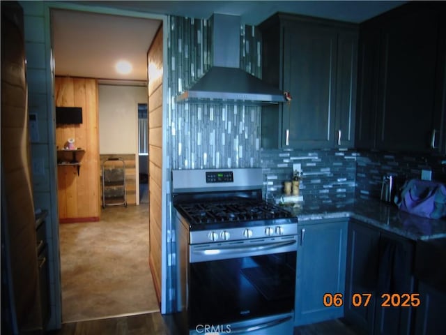 635 5th St, Willows, CA 95988 - kitchen with stainless steel range with gas stovetop, wall chimney range hood, dark stone countertops, and tasteful backsplash