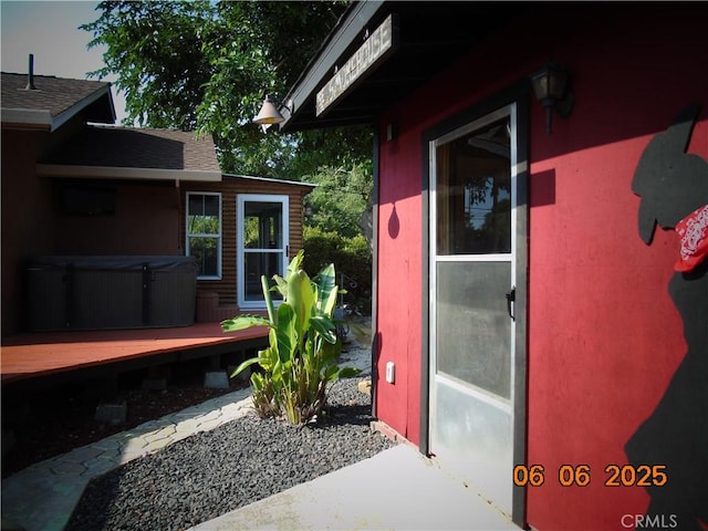 635 5th St, Willows, CA 95988 - property entrance with a hot tub, a wooden deck, and a shingled roof
