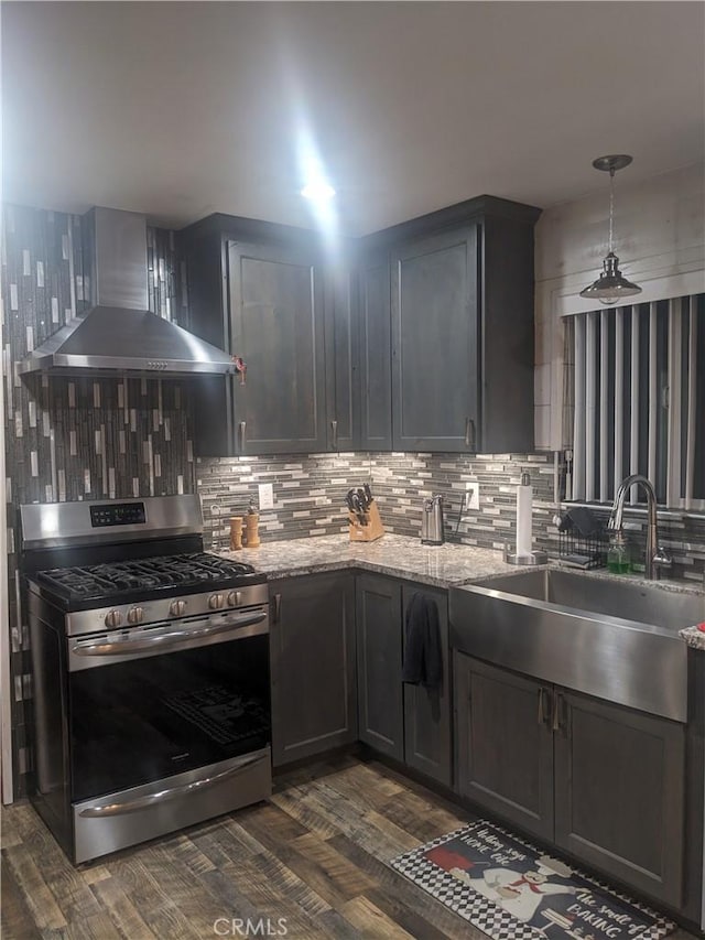 635 5th St, Willows, CA 95988 - kitchen with stainless steel gas range, wall chimney exhaust hood, backsplash, and dark wood-style flooring