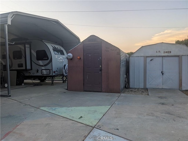 635 5th St, Willows, CA 95988 - outdoor structure at dusk with a storage unit and a carport