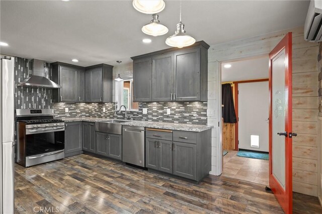 635 5th St, Willows, CA 95988 - kitchen featuring appliances with stainless steel finishes, wall chimney range hood, dark wood-style flooring, tasteful backsplash, and recessed lighting