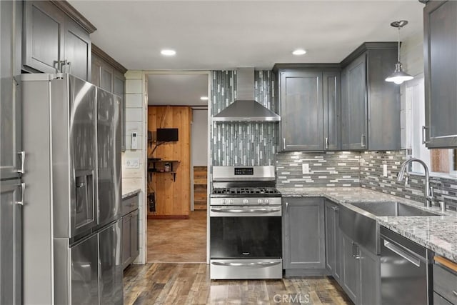 635 5th St, Willows, CA 95988 - kitchen with stainless steel appliances, wall chimney range hood, backsplash, light stone countertops, and light wood-style flooring