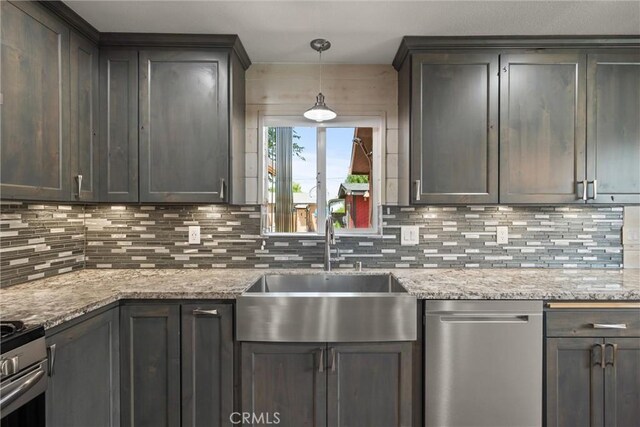 635 5th St, Willows, CA 95988 - kitchen featuring appliances with stainless steel finishes, tasteful backsplash, hanging light fixtures, and light stone counters
