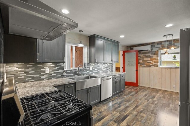 635 5th St, Willows, CA 95988 - kitchen with extractor fan, stainless steel dishwasher, a wall mounted AC, dark wood-style floors, and light stone counters