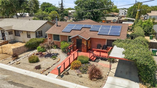 635 5th St, Willows, CA 95988 - ranch-style home featuring a shingled roof, a deck, roof mounted solar panels, and stucco siding