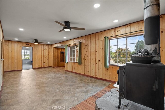 635 5th St, Willows, CA 95988 - living room featuring a ceiling fan, wooden walls, recessed lighting, light wood-style floors, and a wood stove