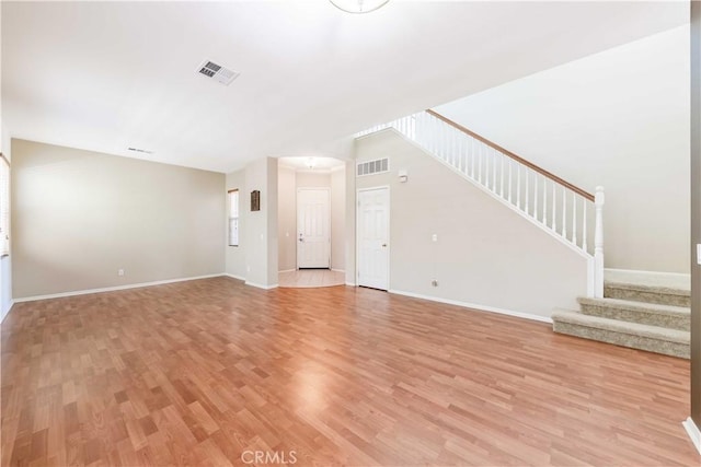 37245 La Lune Ave, Murrieta, CA 92563 - unfurnished living room featuring stairs, light wood-type flooring, and baseboards