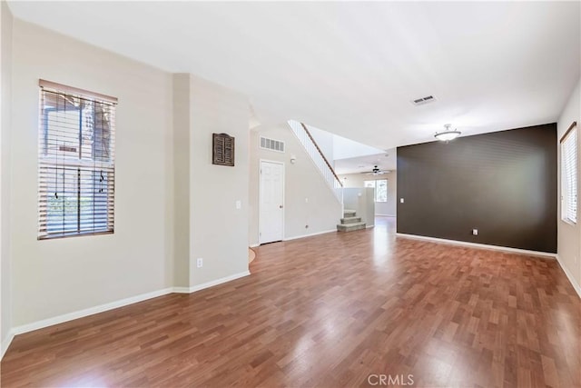 37245 La Lune Ave, Murrieta, CA 92563 - unfurnished living room featuring wood finished floors, baseboards, and stairs