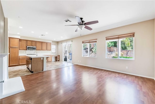 37245 La Lune Ave, Murrieta, CA 92563 - unfurnished living room featuring light wood-style flooring, plenty of natural light, ceiling fan, and recessed lighting