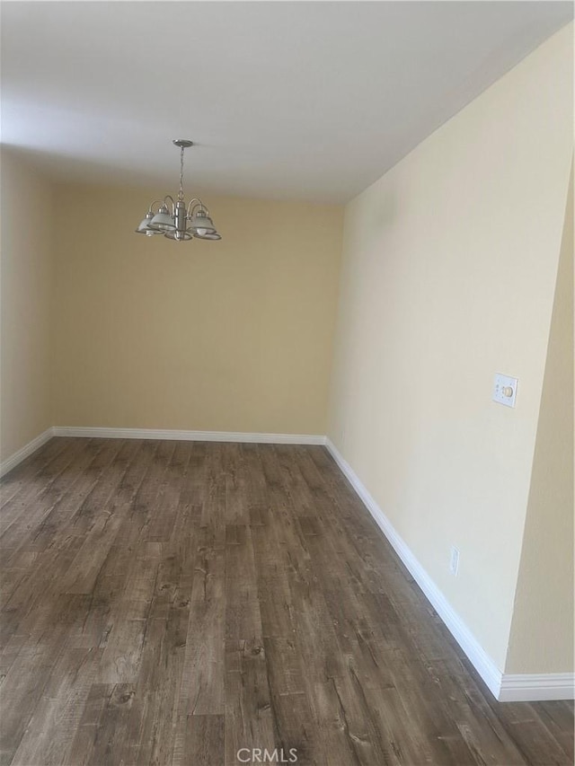 5429 Newcastle Ave Unit 206, Encino, CA 91316 - spare room featuring a chandelier and dark wood-style floors