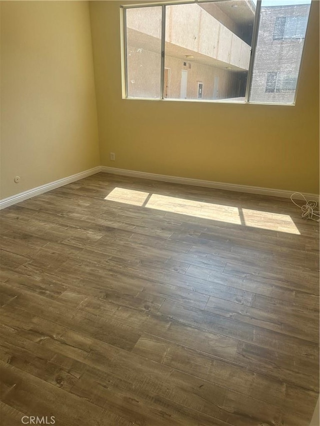 5429 Newcastle Ave Unit 206, Encino, CA 91316 - unfurnished room featuring dark wood-style floors and baseboards