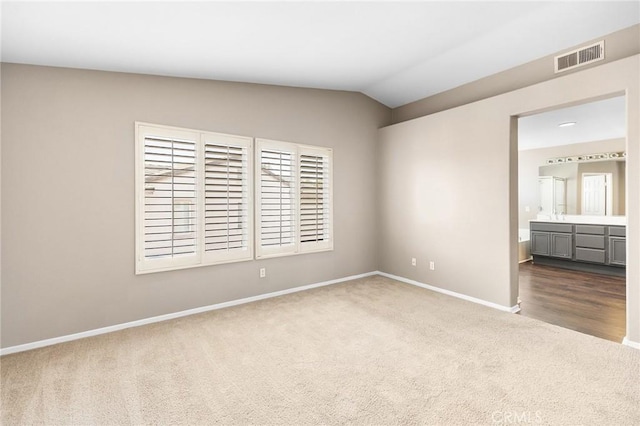 32702 Willowvail Cir, Temecula, CA 92592 - unfurnished bedroom featuring carpet, baseboards, lofted ceiling, and connected bathroom
