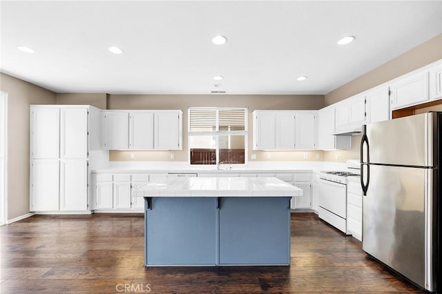 32702 Willowvail Cir, Temecula, CA 92592 - kitchen featuring freestanding refrigerator, tile counters, white range with gas cooktop, a center island, and white cabinets