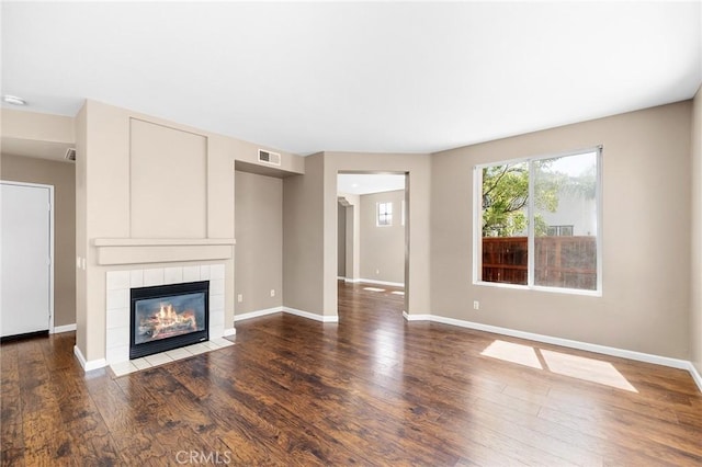 32702 Willowvail Cir, Temecula, CA 92592 - unfurnished living room featuring a tiled fireplace, wood finished floors, and baseboards