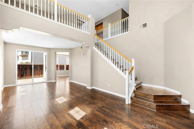 32702 Willowvail Cir, Temecula, CA 92592 - unfurnished living room with stairway, wood finished floors, baseboards, and a towering ceiling