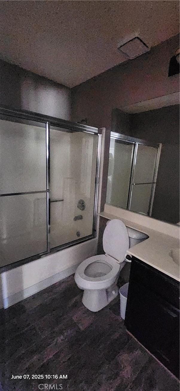 12609 Gentle Breeze Way, Victorville, CA 92392 - full bath featuring toilet, vanity, shower / bath combination with glass door, and wood finished floors