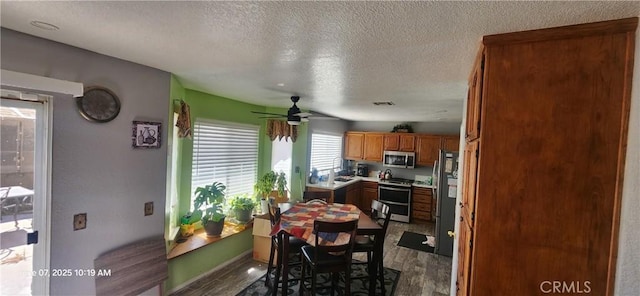 12609 Gentle Breeze Way, Victorville, CA 92392 - dining area with a textured ceiling, a ceiling fan, wood finished floors, and baseboards