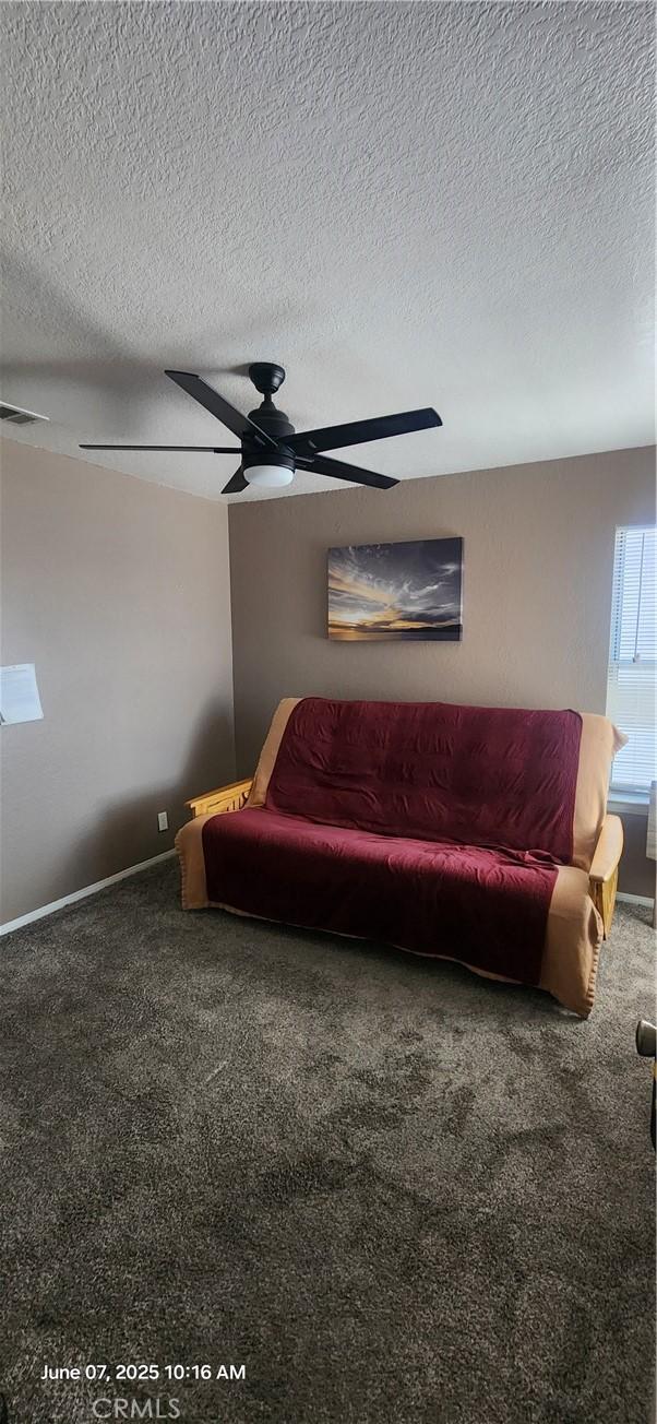 12609 Gentle Breeze Way, Victorville, CA 92392 - living area featuring carpet floors, ceiling fan, a textured ceiling, and baseboards