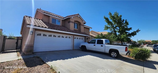 12609 Gentle Breeze Way, Victorville, CA 92392 - view of front of property with a tiled roof, driveway, stucco siding, and a garage