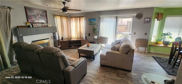 12609 Gentle Breeze Way, Victorville, CA 92392 - living room with a ceiling fan, a fireplace, and baseboards