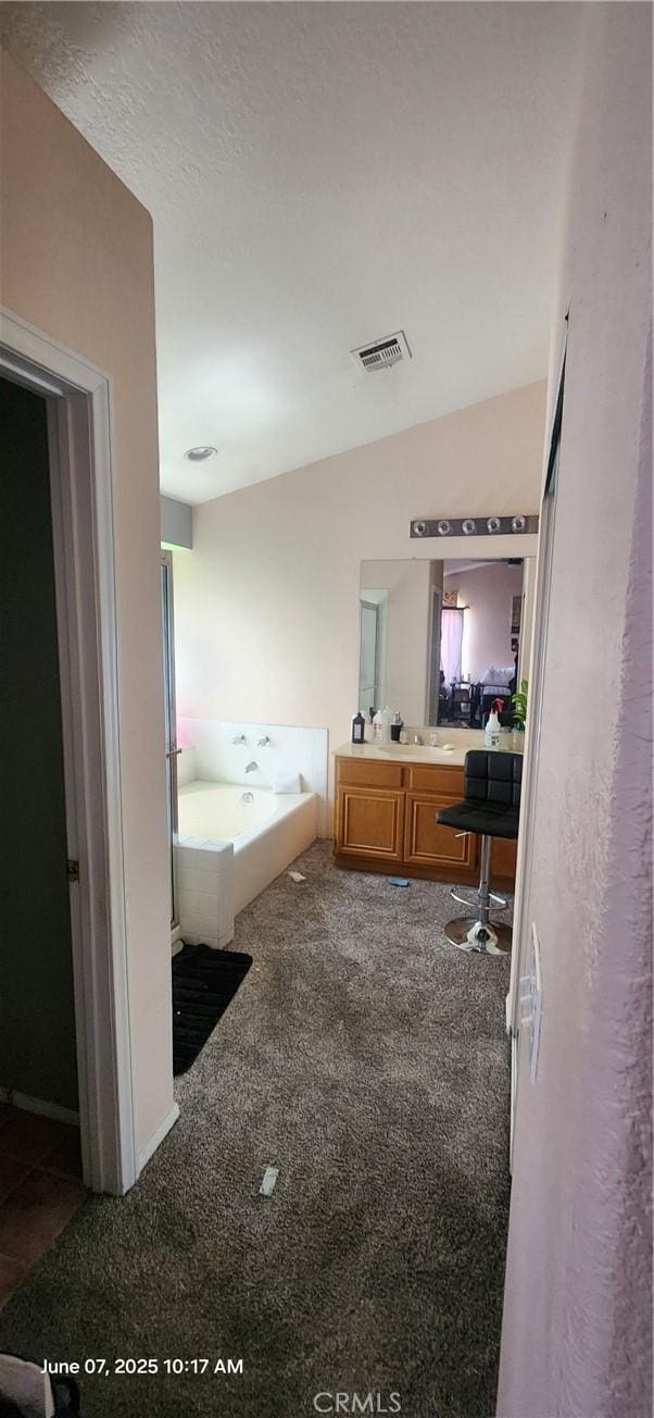 12609 Gentle Breeze Way, Victorville, CA 92392 - bathroom with vanity, carpet flooring, and a bath