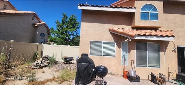 12609 Gentle Breeze Way, Victorville, CA 92392 - back of house with a tile roof, stucco siding, and a patio area