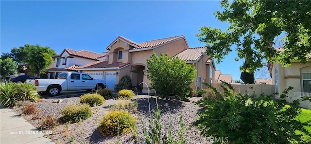 12609 Gentle Breeze Way, Victorville, CA 92392 - view of front of property with stucco siding, a tile roof, and a garage