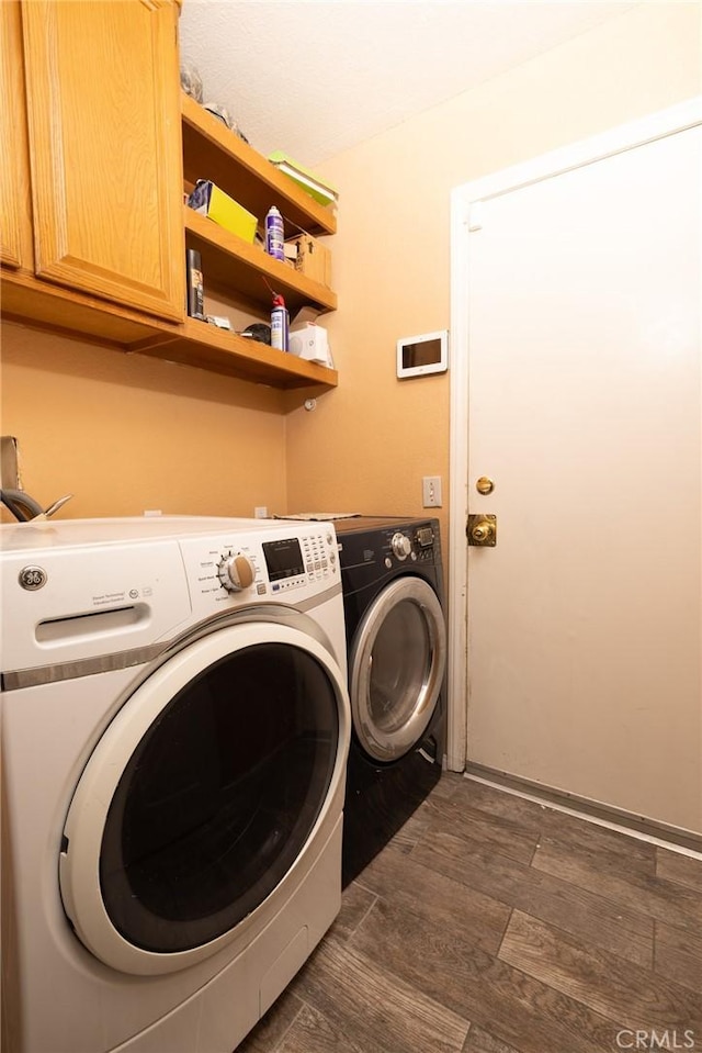 12609 Gentle Breeze Way, Victorville, CA 92392 - laundry area featuring cabinet space, washer and clothes dryer, and dark wood finished floors