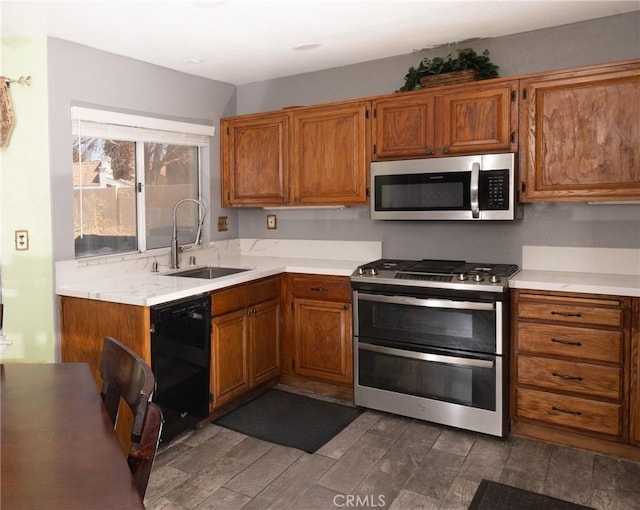 12609 Gentle Breeze Way, Victorville, CA 92392 - kitchen featuring stainless steel appliances, light countertops, brown cabinets, and dark wood-style flooring