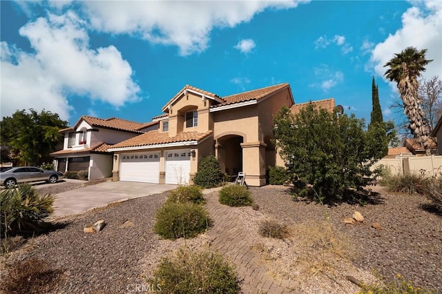 12609 Gentle Breeze Way, Victorville, CA 92392 - mediterranean / spanish-style house featuring stucco siding, concrete driveway, a tile roof, and an attached garage
