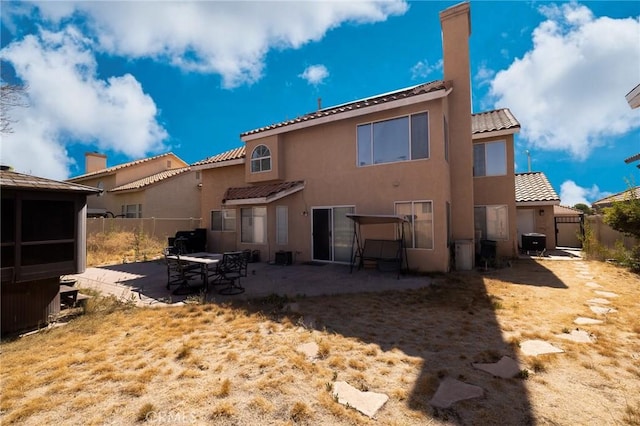 12609 Gentle Breeze Way, Victorville, CA 92392 - rear view of property with a patio area, stucco siding, a tiled roof, and a fenced backyard