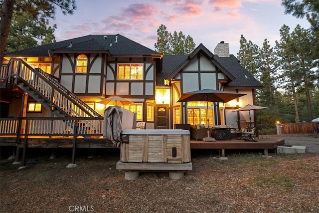 114 Starvation Flats Rd, Big Bear Lake, CA 92315 - back of property featuring a wooden deck, a chimney, stucco siding, and stairway