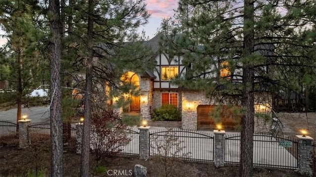 114 Starvation Flats Rd, Big Bear Lake, CA 92315 - view of front of home featuring stone siding and a fenced front yard