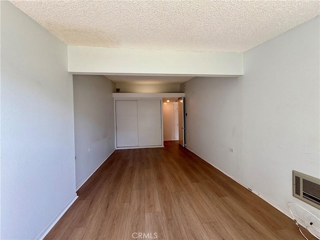 1533 Merion Way Unit 26K, Seal Beach, CA 90740 - unfurnished bedroom featuring wood finished floors and a textured ceiling