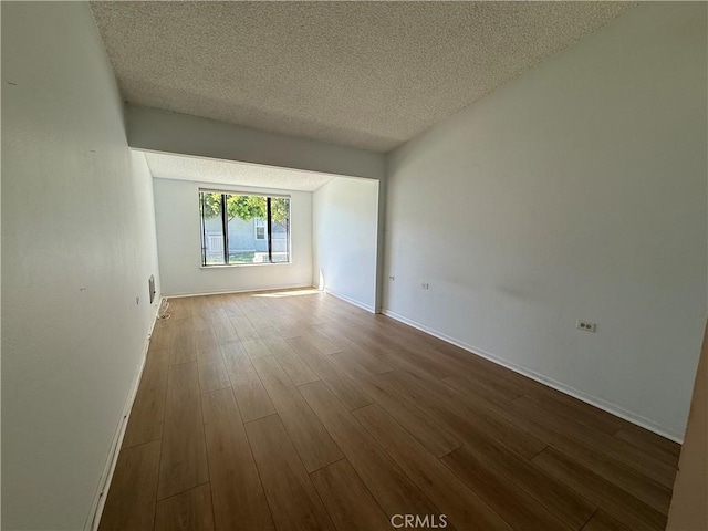 1533 Merion Way Unit 26K, Seal Beach, CA 90740 - empty room featuring a textured ceiling and wood finished floors