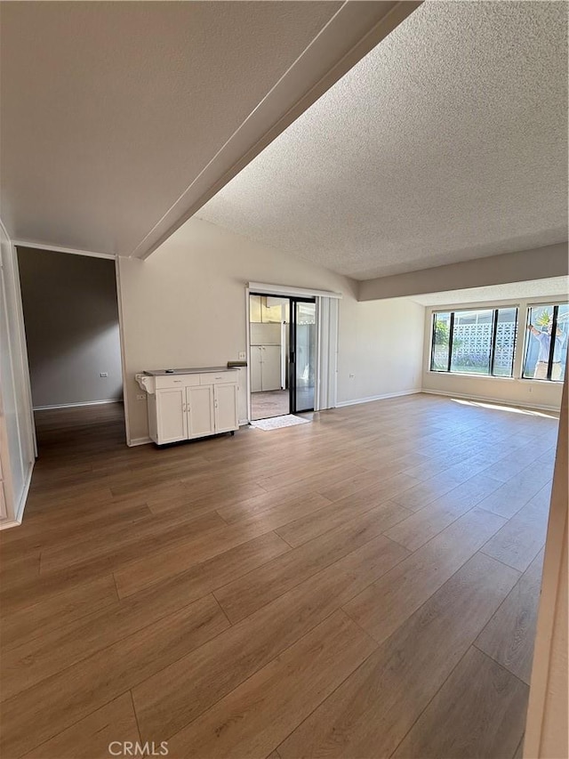 1533 Merion Way Unit 26K, Seal Beach, CA 90740 - unfurnished living room featuring wood finished floors and a textured ceiling