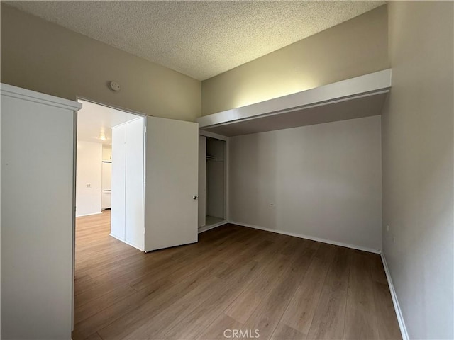 1533 Merion Way Unit 26K, Seal Beach, CA 90740 - unfurnished bedroom featuring wood finished floors, a closet, and a textured ceiling
