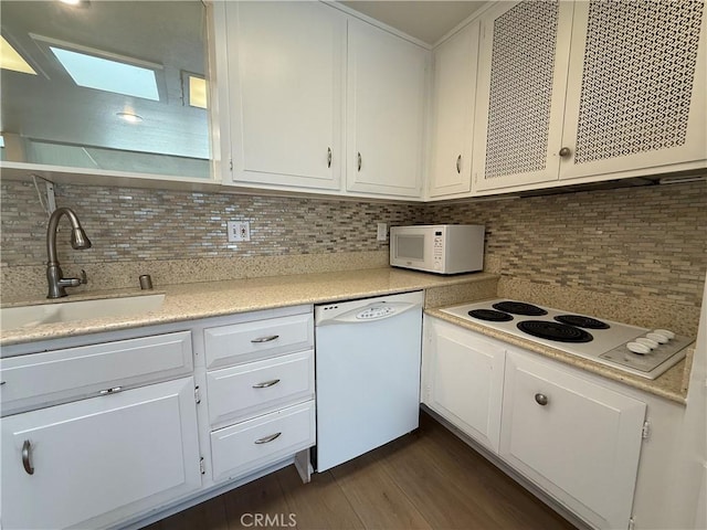 1533 Merion Way Unit 26K, Seal Beach, CA 90740 - kitchen featuring white appliances, backsplash, light countertops, dark wood finished floors, and white cabinetry