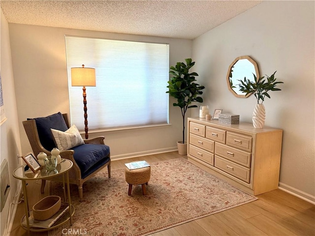 1533 Merion Way Unit 26K, Seal Beach, CA 90740 - living area with light wood-type flooring, healthy amount of natural light, and a textured ceiling