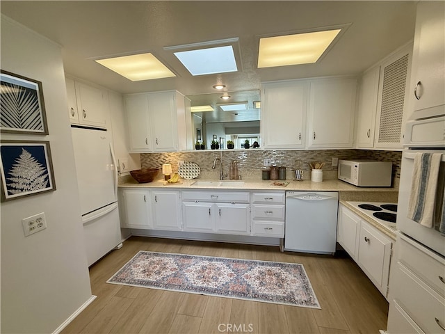1533 Merion Way Unit 26K, Seal Beach, CA 90740 - kitchen with white appliances, white cabinets, and wood finished floors
