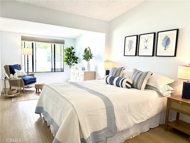1533 Merion Way Unit 26K, Seal Beach, CA 90740 - bedroom featuring wood finished floors and a textured ceiling