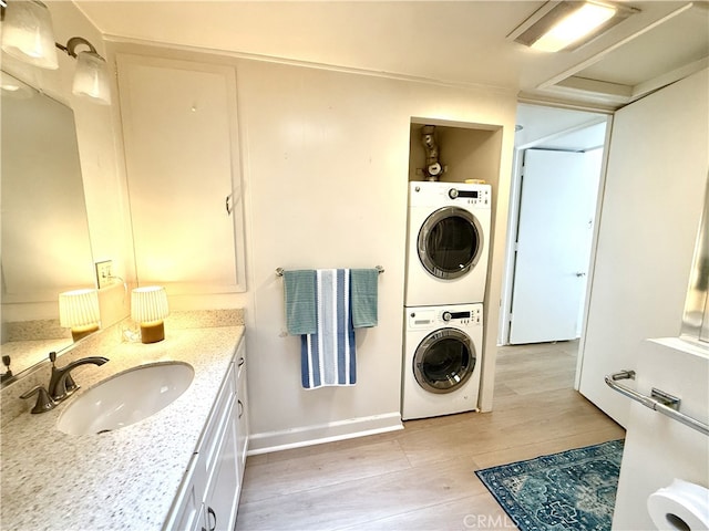 1533 Merion Way Unit 26K, Seal Beach, CA 90740 - bathroom with stacked washer / drying machine, wood finished floors, and vanity