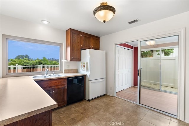 26231 Avenida Calidad, Mission Viejo, CA 92691 - kitchen with dishwasher, freestanding refrigerator, healthy amount of natural light, and light countertops