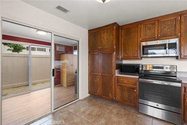 26231 Avenida Calidad, Mission Viejo, CA 92691 - kitchen with appliances with stainless steel finishes, light countertops, and brown cabinets